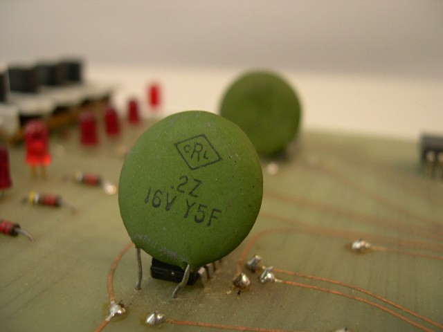 Closeup of ceramic capacitor w/ DATA switches in background.